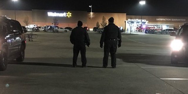 Dec. 3, 2015: Police patrol the parking lot of a Walmart in Darien, Ill. after a shooting left one person injured. (Fox 32 Chicago)