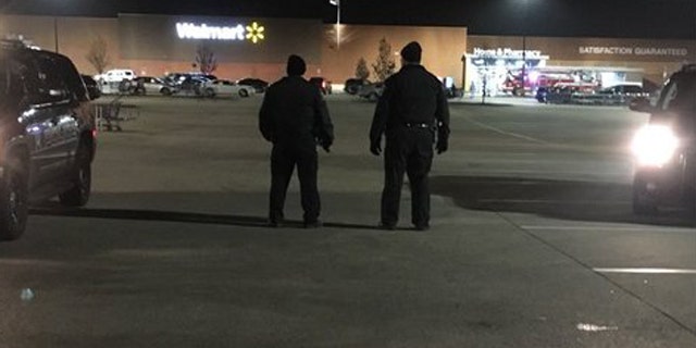 Dec. 3, 2015: Police patrol the parking lot of a Walmart in Darien, Ill. after a shooting left one person injured. (Fox 32 Chicago)