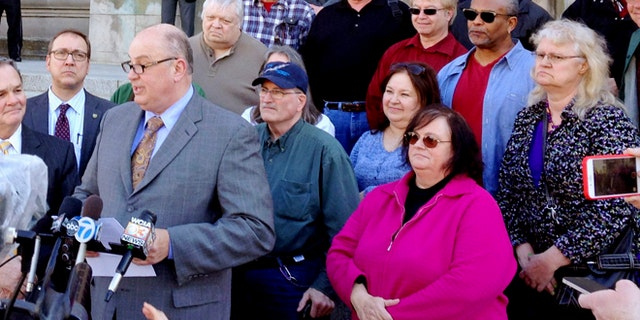 March 11, 2015: Illinois AFL-CIO President Michael Carrigan is joined by state workers and retirees outside the Illinois Supreme Court in Springfield, Ill., as he addresses the media following oral arguments in a lawsuit over a state pension overhaul.