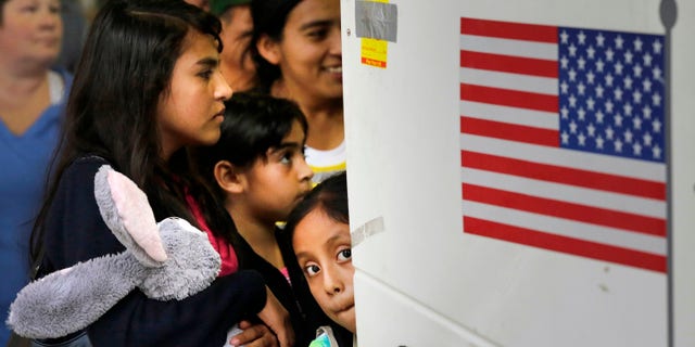 Immigrants from El Salvador and Guatemala board a bus on July 7, 2015.