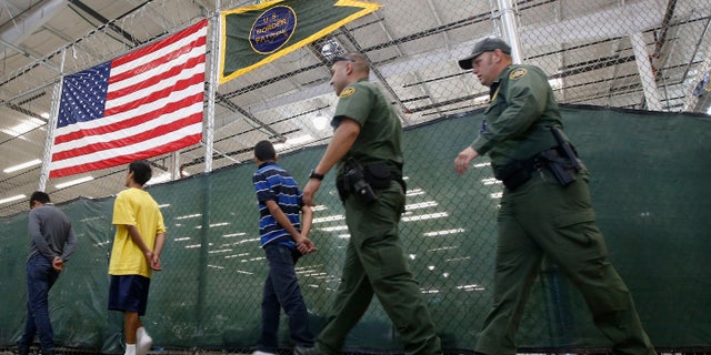 Young detainees being escorted to an area to make phone calls on June 18, 2014 in Nogales, Ariz.