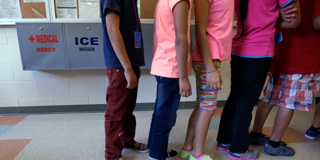 Immigrant children line up in the cafeteria at the Karnes County Residential Center in Karnes City, Texas.