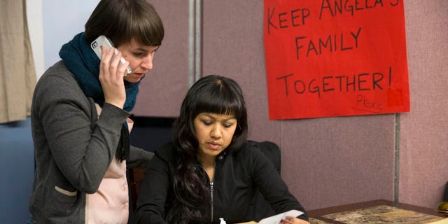 Dec. 8, 2014: Angela Navarro, right, who has been living in the U.S. with her American-born children despite a deportation order issued 10 years ago looks over a letter with New Sanctuary Movement community organizer Nicole Kligerman at the West Kensington Ministry church in Philadelphia. (AP Photo/Matt Rourke)