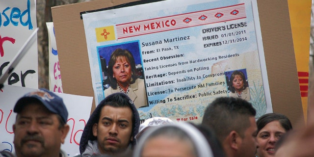 Jan. 24, 2012: Immigrant advocates use an image of New Mexico Gov. Susana Martinez on a mock state driver's license during a rally in Santa Fe to protest her proposal to repeal a state law that allows illegal immigrants to obtain driver's licenses.
