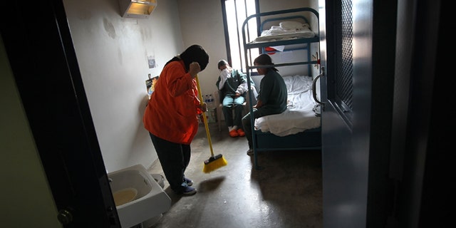 ELOY, AZ - JULY 30: A female detainee cleans a housing cell in a women's wing at an detention facility for illegal immigrants on July 30, 2010 in Eloy, Arizona. Most immigrants at the center are awaiting deportation or removal and return to their home countries, while some are interned at the facility while their immigration cases are being reviewed. The U.S. Immigration and Customs Enforcement (ICE), in Arizona holds almost 3,000 immigrants statewide, all at the detention facilities in Eloy and nearby Florence. Arizona, which deports and returns more illegal immigrants than any other state, is currently appealing a judge's ruling suspending controversial provisions of Arizona's immigration enforcement law SB 1070. (Photo by John Moore/Getty Images)