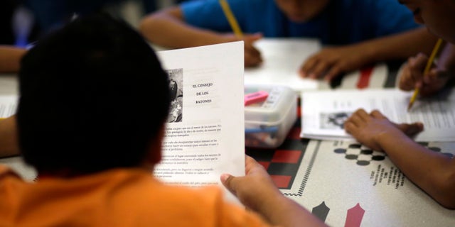 In this Wednesday, Sept. 10, 2014 photo, a short story in Spanish is used in a class at the Karnes County Residential Center, a temporary home for immigrant women and children detained at the border, in Karnes City, Texas. (AP Photo/Eric Gay)