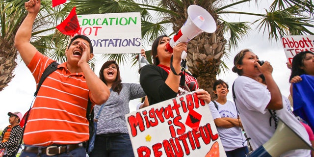 March 19, 2015: Over a hundred protesters stand outside of the federal courthouse in Brownsville, Texas to protest a federal judge's hold on President Obama's executive action on immigration. (AP Photo/The Brownsville Herald, Yvette Vela)