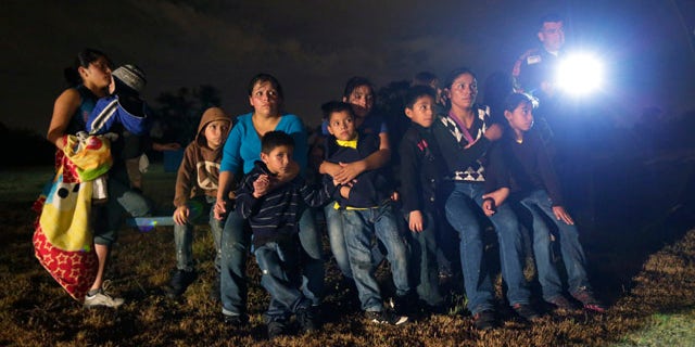 June 25, 2014: A group of immigrants from Honduras and El Salvador who crossed the U.S.-Mexico border illegally are stopped in Granjeno, Texas. (AP Photo/Eric Gay)