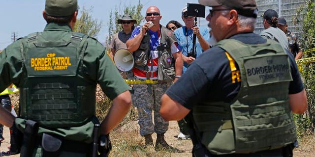 Border patrol officers during a immigration demonstration outside the Border Patrol facility Friday, July 4, 2014 in Murrieta, Calif.
