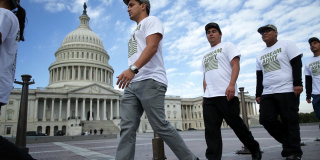 WASHINGTON, DC - OCTOBER 23:   (L-R) Lizardo Buleje of San Antonio, Texas, Jorge Tellez of Parker, Colorado, Anthony Corona of Staten Island, New York, and Armando Jimenez of Allen Town, Pennsylvania, march in front of the U.S. Capitol during a rally on immigration reform October 23, 2013 on Capitol Hill in Washington, DC. The Dream Action Coalition held a rally and briefing to discuss "how the outdated immigration system undermines military readiness, separates military families, and prevents talent from joining its enlisted and officer ranks." (Photo by Alex Wong/Getty Images)