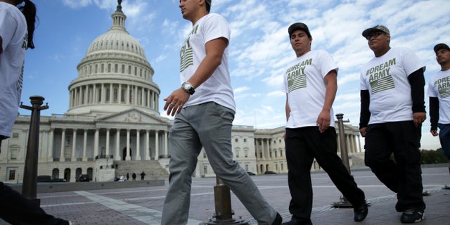 WASHINGTON, DC - OCTOBER 23: (L-R) Lizardo Buleje of San Antonio, Texas, Jorge Tellez of Parker, Colorado, Anthony Corona of Staten Island, New York, and Armando Jimenez of Allen Town, Pennsylvania, march in front of the U.S. Capitol during a rally on immigration reform October 23, 2013 on Capitol Hill in Washington, DC. The Dream Action Coalition held a rally and briefing to discuss "how the outdated immigration system undermines military readiness, separates military families, and prevents talent from joining its enlisted and officer ranks." (Photo by Alex Wong/Getty Images)