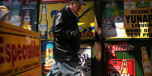 UNION CITY, NJ - MARCH 28: A man walks by adds in Spanish outside of a bodega on March 28, 2011 in Union City, New Jersey. Union City New Jersey, one of the stateâs largest cities, has a population of Hispanic or Latino origin of over 80%. According to the new 2010 Census Bureau statistics reported last Thursday, the Hispanic population in the United States has grown by 43% in the last decade, surpassing 50 million and accounting for about 1 out of 6 Americans. (Photo by Spencer Platt/Getty Images)