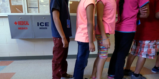 FILE - In this Sept. 10, 2014 file photo, detained immigrant children line up in the cafeteria at the Karnes County Residential Center in Karnes City, Texas. Karnes, one of the nation's largest detention centers for families caught crossing the southern U.S. border received a temporary residential child-care license from the Texas Department of Family and Protective Services. DFPS spokesman Patrick Crimmins said Tuesday May 3, 2016, the agency granted the six-month license last week to the facility. (AP Photo/Eric Gay, File)