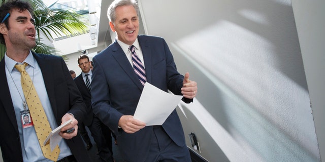 House Majority Leader Kevin McCarthy of Calif., center, walks with a reporters as on Capitol Hill in Washington, Friday, Jan. 9, 2015, as House Republicans leave a closed-door meeting on thwarting President Barack Obama's executive actions on immigration by blocking the funding for the Department of Homeland Security, Obama's directives in November gave temporary relief from deportation to about 4 million immigrants in the country illegally, along with permits allowing them to work legally in the U.S. His move infuriated Republicans after their midterm election victories, and they vowed to retaliate once they assumed full control of Congress this week. (AP Photo/J. Scott Applewhite)