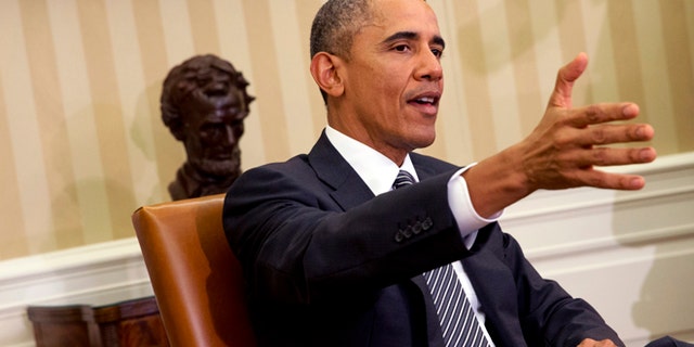 President Barack Obama speaks to the media during a meeting with Secretary of Defense Ash Carter in the Oval Office of the White House, Tuesday, Feb. 17, 2015, in Washington. The President spoke about issues including immigration and ISIS. (AP Photo/Jacquelyn Martin)