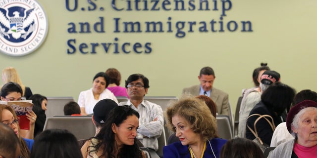 NEW YORK, NY - MAY 30: Immigrants await their turn for green card and citizenship interviews at the U.S. Citizenship and Immigration Services (USCIS) Queens office on May 30, 2013 in the Long Island City neighborhood of the Queens borough of New York City. The branch office is located in an area heavily populated by immigrants and processes thousands of Green Card and U.S. citizenship applications each year. (Photo by John Moore/Getty Images)