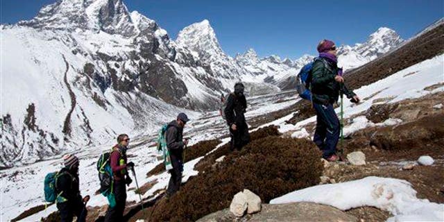In this March 18, 2015, file photo, trekkers take an acclimatization hike on the way to Everest base camp in Nepal.