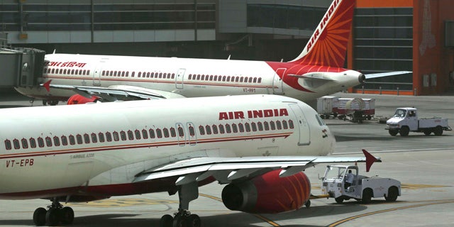 FILE - In this May 18, 2012, file photo, Air India planes are parked on the tarmac at the Terminal 3 of Indira Gandhi International Airport in New Delhi, India. (AP Photo/Kevin Frayer, File)