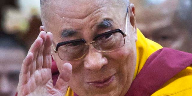 Sept. 7, 2015: Tibetan spiritual leader the Dalai Lama greets devotees as he arrives to give a talk at the Tsuglakhang temple in Dharmsala, India.