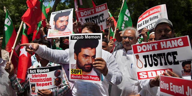 July 27, 2015: Activists of the Social Democratic Party of India carry placards with portraits of Yakub Abdul Razak Memon, convicted in the 1993 Mumbai bombings, during a protest against his death sentence outside Maharashtra House in New Delhi. (AP Photo/Tsering Topgyal)