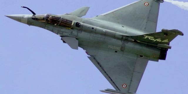 FILE - In this June 21, 2001 file photo, a French Air Force Rafale manufactured by France's Dassault Aviation speeds above Le Bourget airport, north of Paris, during the 44th Paris Air Show, in France. A French defense official said Tuesday, Dec. 2, 2014, India is close to finalizing a deal to buy 126 Rafale fighter planes for about 12 billion euros ($15 billion). It would mark France’s first foreign sale of the combat-tested planes. (AP Photo/Remy de la Mauviniere, File)