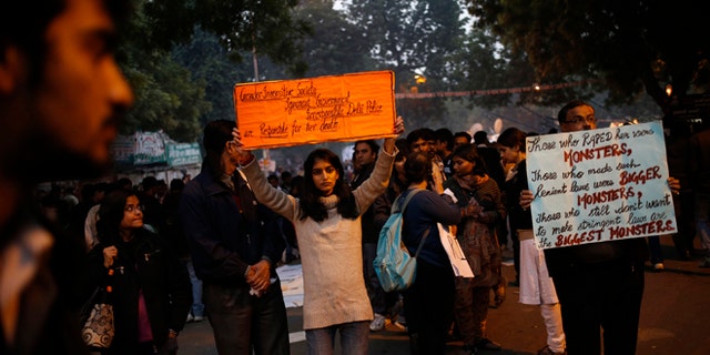 Dec. 29, 2012: Indian women and men hold placards as they mourn the death of a gang rape victim in New Delhi, India.