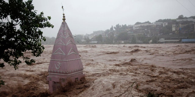 September 6, 2014: A temple is partially submerged in floodwaters in Jammu, India. (AP Photo/Channi Anand)
