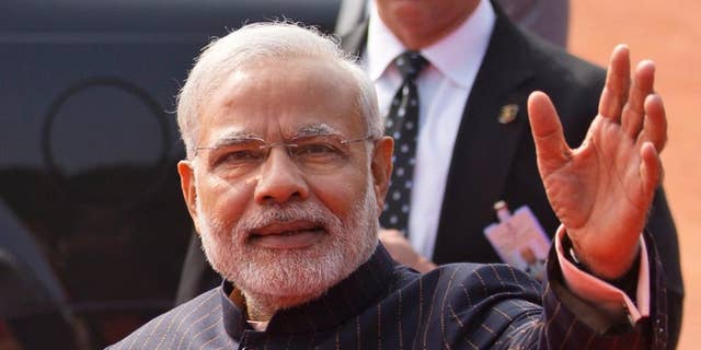 Jan. 25, 2015: Indian Prime Minister Narendra Modi waves during a reception for President Obama in New Delhi.