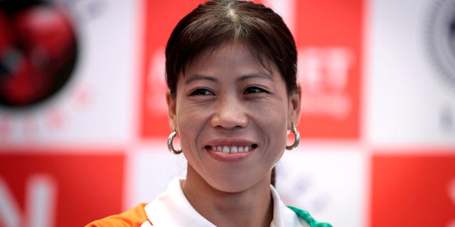 July 12, 2012: Indian woman boxer M.C. Mary Kom, who will compete in the upcoming Olympic Games, smiles during a press conference in New Delhi, India.