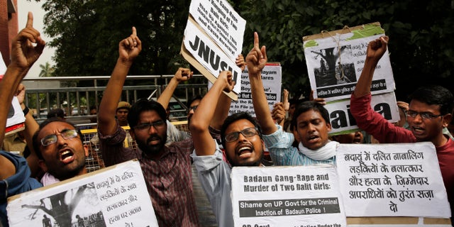 May 30, 2014 - Members of Jawaharlal Nehru University Students Union shout slogans during a protest against a gang rape of two teenage girls in Katra village, outside a statehouse in New Delhi, India. A top government official said the Uttar Pradesh state fired 2 police officers who failed to respond to a complaint by the father of the 2 teenage girls who went missing and were later found gang raped and killed. Sign at right reads "Punish the culprits of gang-rape and murder of two Dalit girls."