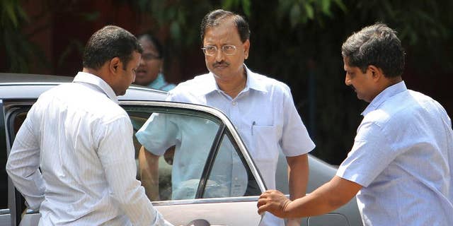 Satyam Computer Services founder B. Rama Raju, centre, arrives at a court in Hyderabad, India, Thursday, April 9, 2015. An Indian court on Thursday convicted Raju, the founder of the outsourcing giant and nine others on charges of stealing millions of dollars in one of the largest frauds in the country's corporate history. (AP Photo/Mahesh Kumar A.)