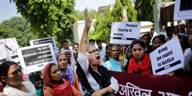 FILE - In this Thursday, Sept. 10, 2015 file photo, activists of All India Democratic Women's Association shout slogans during a protest outside the Saudi Arabian embassy in New Delhi, India. Indian officials say a Saudi Arabian diplomat accused of repeatedly raping and abusing two women has left India under the cover of diplomatic immunity. (AP Photo/Altaf Qadri, File)