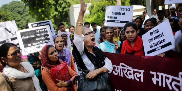 FILE - In this Thursday, Sept. 10, 2015 file photo, activists of All India Democratic Women's Association shout slogans during a protest outside the Saudi Arabian embassy in New Delhi, India. Indian officials say a Saudi Arabian diplomat accused of repeatedly raping and abusing two women has left India under the cover of diplomatic immunity. (AP Photo/Altaf Qadri, File)