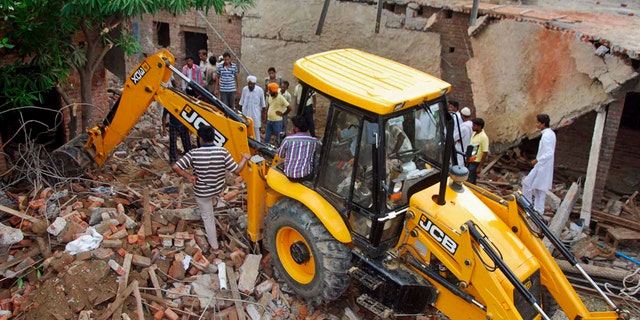 July 27, 2012- Indian rescue workers try to clean the debris after a school roof collapsed in Bijnore 185 miles southwest of state capital Lucknow, India.
