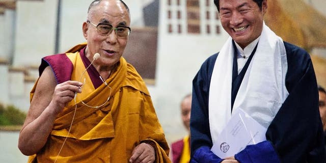 Lobsang Sangay, prime minister of the Tibetan government-in-exile, right, smiles as he listens to spiritual leader the Dalai Lama at the Tibetan Children’s Village School in Dharmsala, India, Thursday, June 5, 2014. (AP Photo/Ashwini Bhatia)