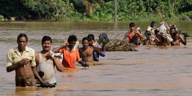 Sept. 28: Villagers ford floodwaters at Patamundi near Kendrapara, about 75 miles north of Bhubaneshwar, India.