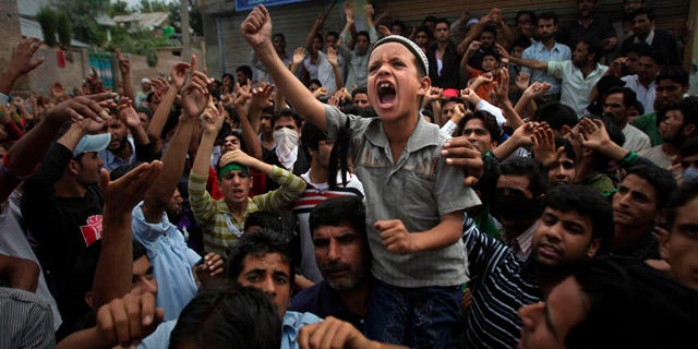 Sept. 13, 2010: A young Kashmiri boy shouts slogans during a protest on the outskirts of Srinagar, India. Indian forces battled Kashmiri protesters in the streets of the disputed territory Monday in demonstrations fueled in part by a report of the Quran being desecrated in the United States.