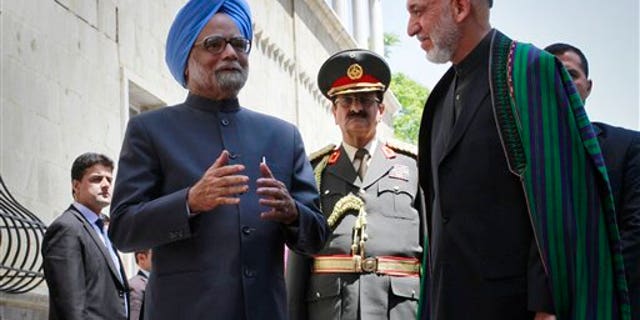 May 12: Indian Prime Minister Manmohan Singh speaks to the media, as Afghan President Hamid Karzai listens to him at the presidential palace in Kabul, Afghanistan.