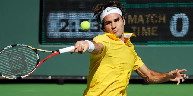 March 15: Roger Federer, of Switzerland, returns a shot to Juan Ignacio Chela, of Argentina, during their match at the BNP Paribas Open tennis tournament in Indian Wells, Calif.