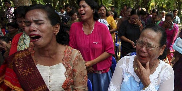 Oct. 18: Residents cry as they attend a Sunday mass prayer near a burned church at Suka Makmur Village in Aceh Singkil.