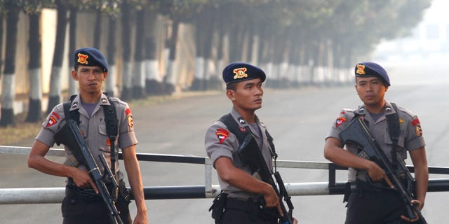 August 11: Armed officers man a checkpoint at the gate of a police compound where Indonesian militant, Umar Patek, is detained on the outskirts of Jakarta, Indonesia. Patek, who allegedly made the explosives used in the 2002 Bali bombings, returned to his homeland under tight security more than six months after he was captured in northwest Pakistan, officials said.