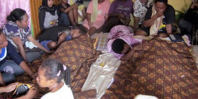 July 15, 2013 - Relatives mourn around the bodies of Yanus Manibui and his wife Anance Woyaa who were victims in a stampede at Kota Lama Sport Stadium after spectators rioted to protest a local boxer's loss in Nabire, Papua province, Indonesia. More than a dozen people were killed in the stadium stampede. The victims, mostly women, were trampled to death as about 1,500 spectators scrambled out of the stadium to escape the riot.
