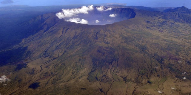 Oct. 19, 2010" Mount Tambora's 10 kilometer wide and 1 kilometer deep volcanic crater, created by the April 1815 eruption, is shown. Bold farmers routinely ignore orders to evacuate the slopes of live volcanos in Indonesia, but those on Tambora took no chances when history's deadliest mountain rumbled ominously this month, Sept., 2011.