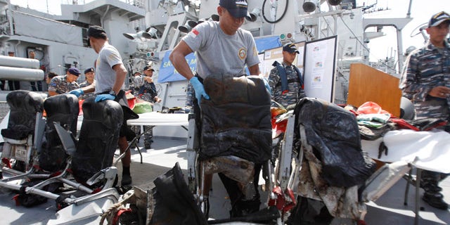 Jan. 5, 2015: Crew members of Indonesian Navy ship KRI Bung Tomo show airplane seats from AirAsia Flight 8501 recovered during search operations for the ill-fated jetliner during a press conference at the Navy's Eastern Fleet Naval Base in Surabaya, East Java. (AP Photo/Trisnadi)