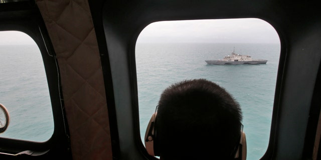 Jan. 6, 2015: A military ship is seen from Indonesian Air Force NAS 332 Super Puma helicopter during a search operation for the victims of AirAsia Flight 8501, off Pangkalan Bun, Central Borneo. (AP Photo/Achmad Ibrahim, Pool)