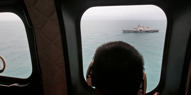 Jan. 6, 2015: A military ship is seen from Indonesian Air Force NAS 332 Super Puma helicopter during a search operation for the victims of AirAsia Flight 8501, off Pangkalan Bun, Central Borneo. (AP Photo/Achmad Ibrahim, Pool)