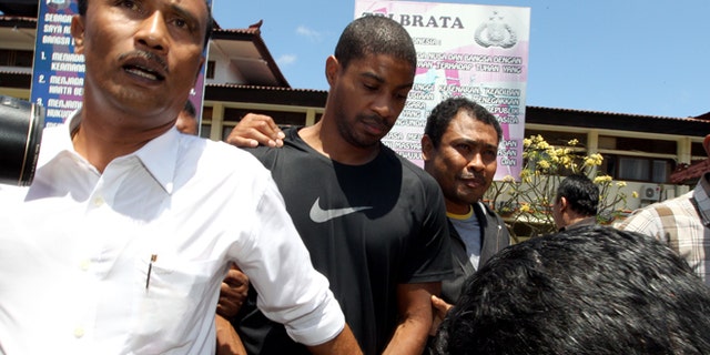 Sept. 2, 2015: Former Austin,Texas, police officer VonTrey Jamal Clark, center, is escorted by Indonesian police officers during his extradition in connection with a murder case at the regional police headquarters in Bali, Indonesia.