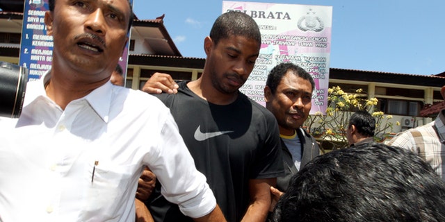 Sept. 2, 2015: Former Austin,Texas, police officer VonTrey Jamal Clark, center, is escorted by Indonesian police officers during his extradition in connection with a murder case at the regional police headquarters in Bali, Indonesia.