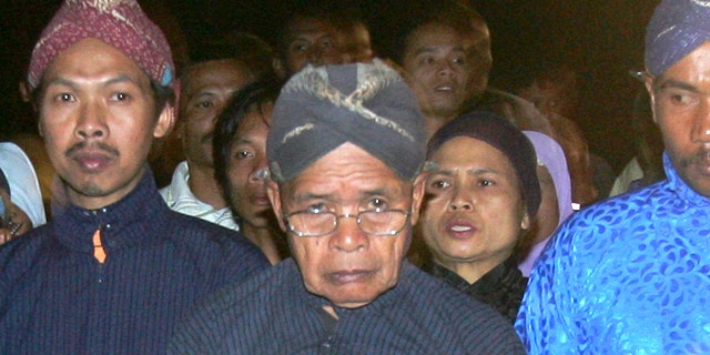 Maridjan (center), the spiritual guardian of Mount Merapi, performas a midnight walk in silence with other villagers in this 2006 photo. For 33 years, Maridjan spoke to Mount Merapi, appeasing its unpredictable spirits by offering of rice, clothes and chickens to the volcano that recently took his life.