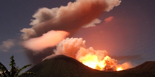 July 14, 2011: The glow of lava from Mount Lokon's eruption is seen against the night sky from Tomohon, North Sulawesi, Indonesia.